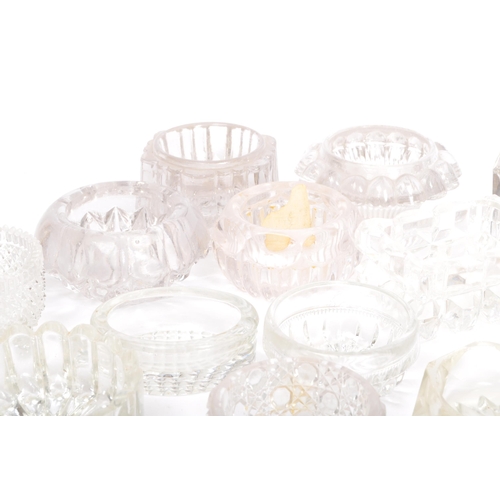 78 - A large collection of 20th century cut glass and pressed glass salts in a variety of shapes.