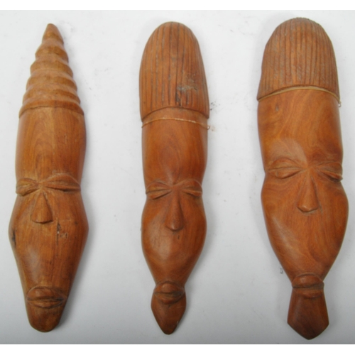 267 - A collection of African tribal tourist Zambian items. Comprising of three carved wall plaque decorat... 