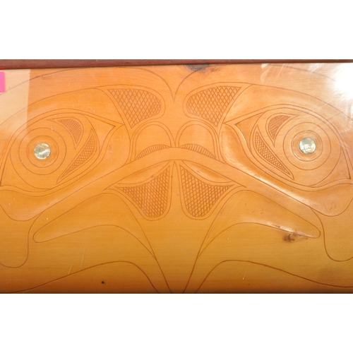 269 - A 20th century Polynesian carved wooden tray. The tray having inlaid mother of pearl and paddles car... 