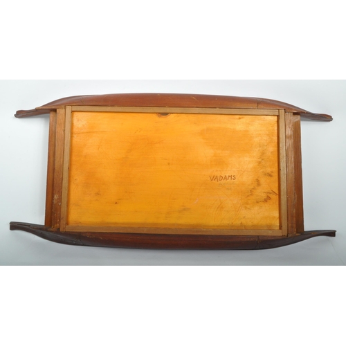 269 - A 20th century Polynesian carved wooden tray. The tray having inlaid mother of pearl and paddles car... 