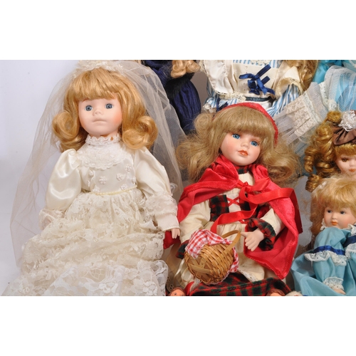 274 - A collection of assorted vintage porcelain headed dolls. Firmly stuffed cloth body with porcelain he... 