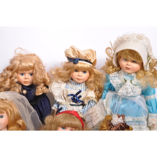 274 - A collection of assorted vintage porcelain headed dolls. Firmly stuffed cloth body with porcelain he... 