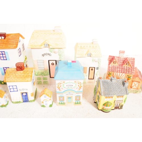 74 - A collection of 20th century cookie / biscuit jars to include large examples of houses / cottages, s... 