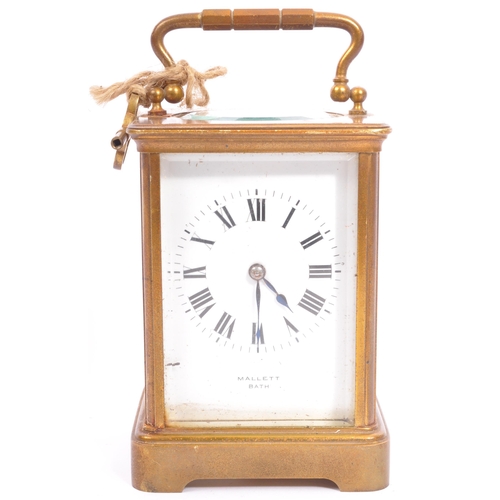 310 - A large early 20th century brass carriage clock. The clock having white enamelled face marked for Ma... 