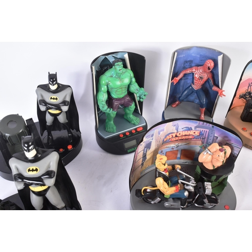 554 - A collection of vintage digital radio alarm clocks. Largely action figure themed to include Batman; ... 