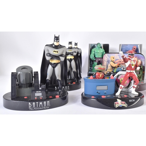 554 - A collection of vintage digital radio alarm clocks. Largely action figure themed to include Batman; ... 