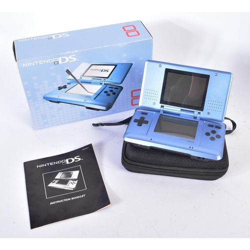 593 - Retro Gaming - a boxed Nintendo DS hand held video game console with a selection of games to include... 