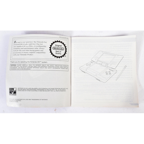 593 - Retro Gaming - a boxed Nintendo DS hand held video game console with a selection of games to include... 