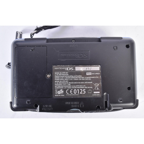 593 - Retro Gaming - a boxed Nintendo DS hand held video game console with a selection of games to include... 