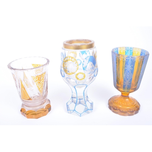 12 - Three 20th Century Czech glass goblets in the manner of Moser. Comprises an example decorated with c... 