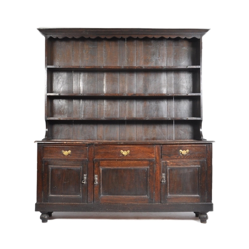 19 - An 18th century George III oak Welsh dresser. Raised on bracket feet supporting a wide body of three... 