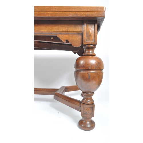 27 - An early 20th century large oak and parquetry draw leaf refectory dining table in the manner of Rube... 