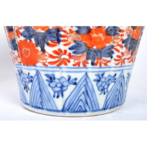 35 - A pair of late nineteenth century Japanese Imari urns, featuring blue and red floral motifs and patt... 