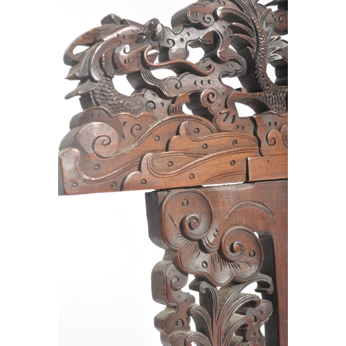 38 - A 19th century Chinese hardwood screen. Heavily carved and detailed being raised on dragon foot base... 