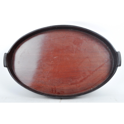 39 - An 18th Century George III mahogany and brass bound serving tray. The tray of oval form with gallery... 