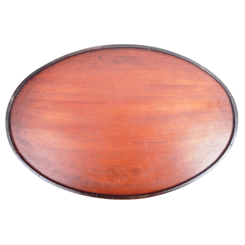 39 - An 18th Century George III mahogany and brass bound serving tray. The tray of oval form with gallery... 