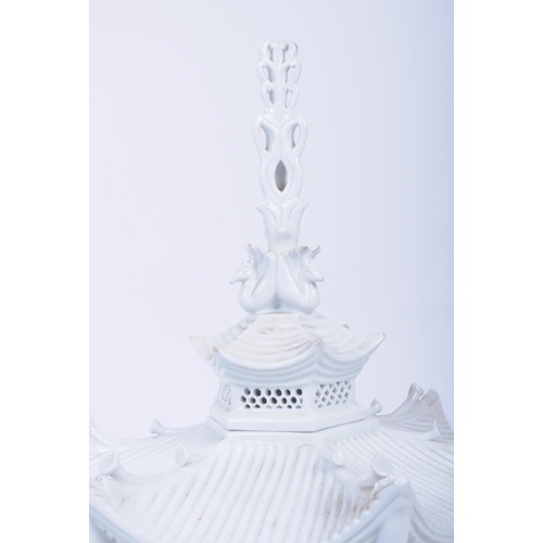 41 - An early 20th century Blanc De Chine urn / lidded vase in form of stylised pagoda, with scrolling sp... 