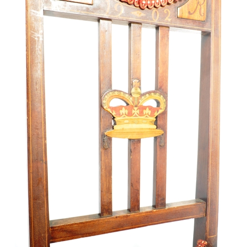 48 - An Edwardian mahogany inlaid investiture chair being raised on tapered legs with stretchers having t... 