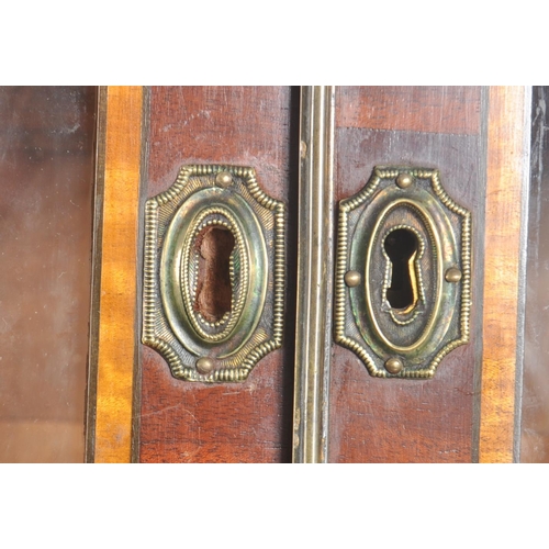 65 - A high Victorian early 20th century flame mahogany secretaire bookcase having an inlaid glazed top w... 