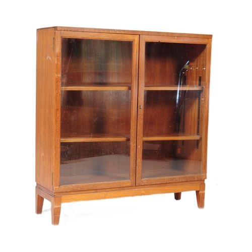 552 - British Modern Design - A mid century teak wood library bookcase cabinet. Raised on squared legs wit... 