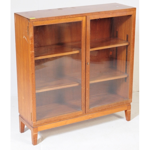 552 - British Modern Design - A mid century teak wood library bookcase cabinet. Raised on squared legs wit... 