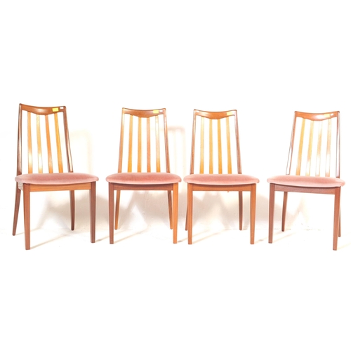 554A - A retro, 20th Century 1970's teak dining table and four chairs by G-Plan. The table of large oval fo... 