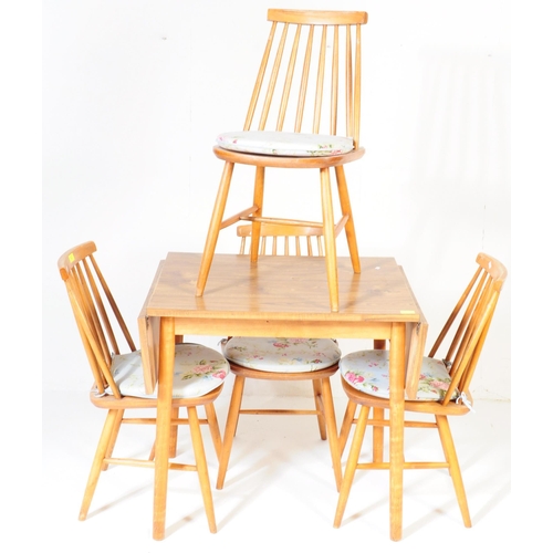 565 - A set of four mid 20th century retro vintage teak Ercol style dining chairs having spindle backs ove... 