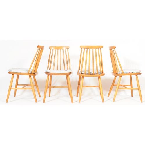 565 - A set of four mid 20th century retro vintage teak Ercol style dining chairs having spindle backs ove... 