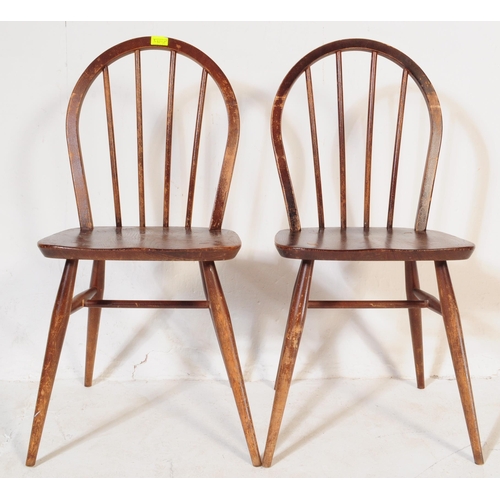 571a - A pair of retro vintage mid 20th century Ercol beech and elm dining chairs having hoop back with spi... 