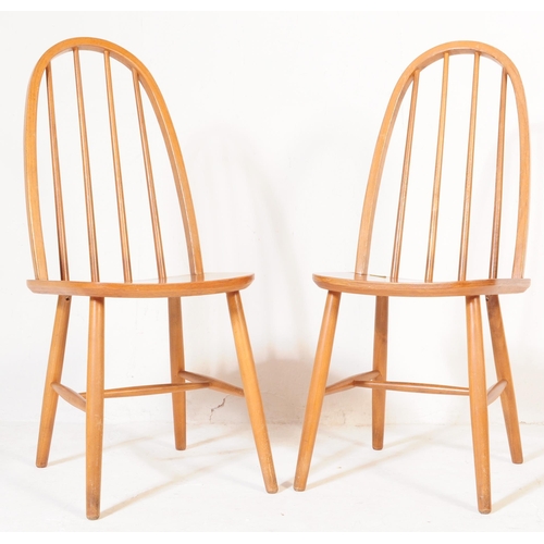 600 - A pair of retro vintage, mid 20th Century beech, high back Windsor style chairs, in the manner ofÂ L... 