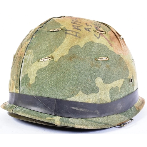 103 - A Vietnam War era US United States M1 steel combat helmet with reversible camo cover. Swivel bale ex... 