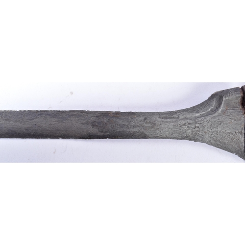 126 - An early 20th Century Malayan Kris / Keris dagger. Carved wooden hilt with typical wavy blade housed... 