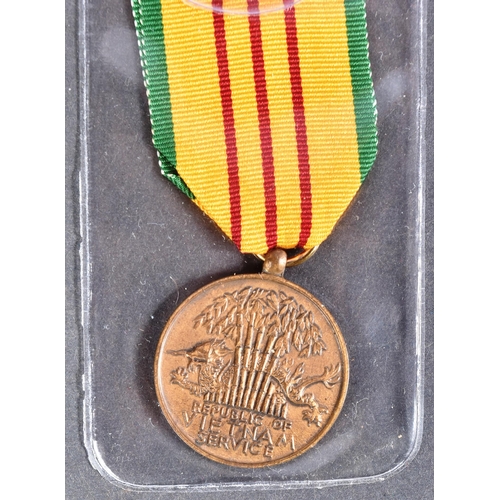 151 - An original US United States Armed Forces Vietnam War Service medal along with a US Army Corporal pa... 