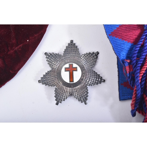 197 - An original Masonic Knights Templar uniform regalia comprising mantle and tunic, maroon velvet cap, ... 