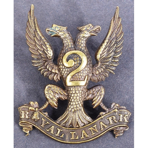 224 - A collection of assorted British Military cap badges along with some uncut examples to include; Roya... 