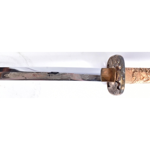 226 - A 20th Century Japanese Katana / Samurai sword with a hidden knife. Brass capped pommel with a carve... 