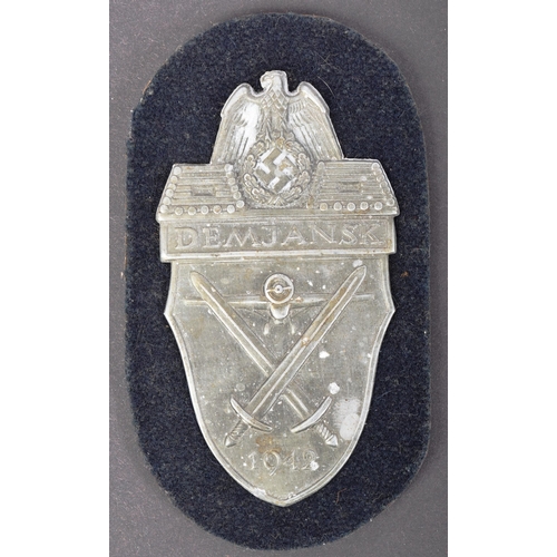 A WWII Second World War Third Reich Nazi German Demjansk campaign shield.  Die struck metal badge wit