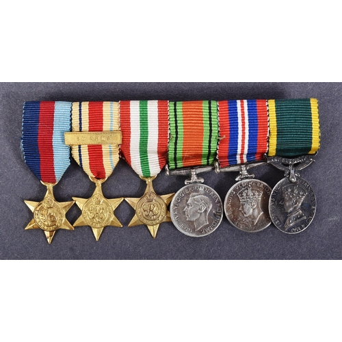 52 - A WWII Second World War miniature medal group suspended on original ribbons and mounted onto a bar. ... 