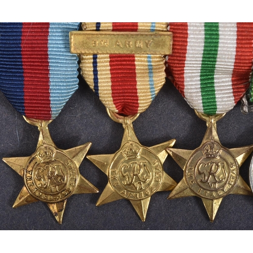 52 - A WWII Second World War miniature medal group suspended on original ribbons and mounted onto a bar. ... 