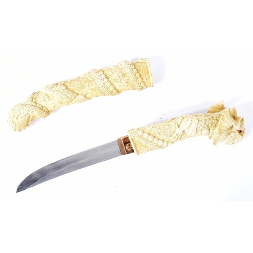 62 - A vintage Japanese style Tanto knife. Resin construction carved to a mythical dragon wrapping around... 