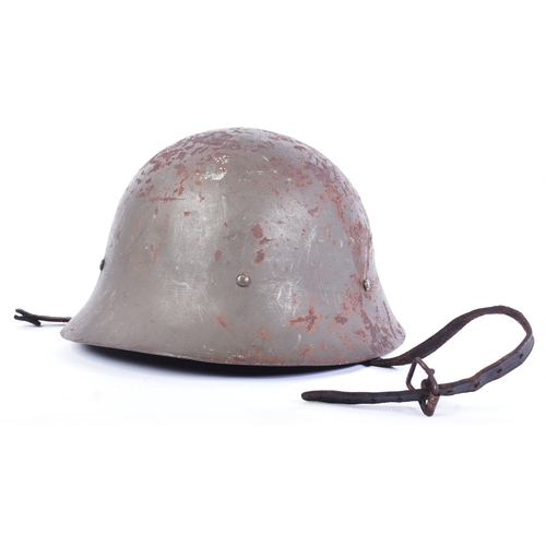 82 - A WWII Second World Japanese Civil Defence / Home Guard type steel helmet. Dark green paintwork with... 