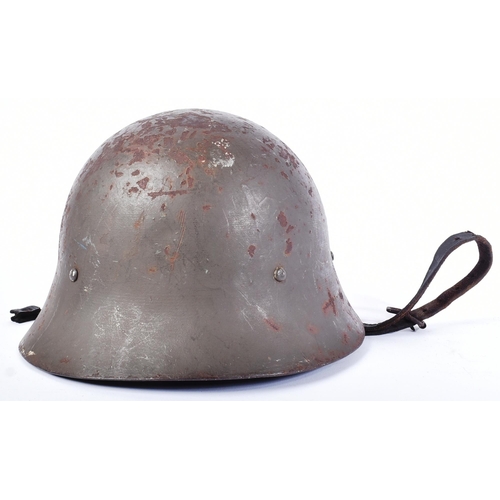 82 - A WWII Second World Japanese Civil Defence / Home Guard type steel helmet. Dark green paintwork with... 