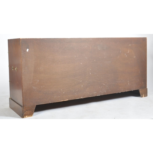 134 - A retro vintage 20th century mahogany campaign style brass bound chest sideboard. The chest of drawe... 