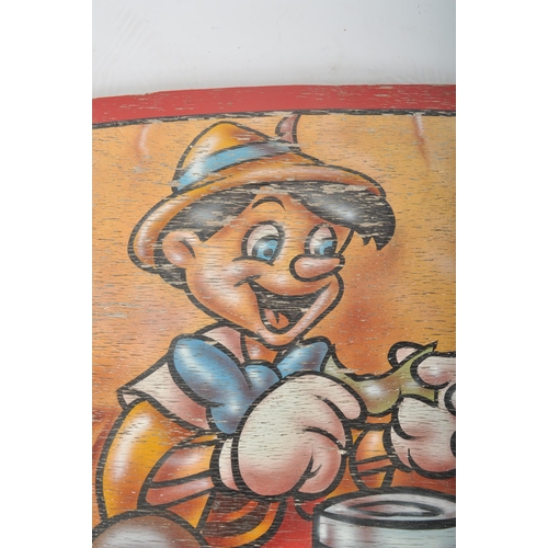 141 - A contemporary well weathered painted wooden fairground / funfair panel featuring Disney's Pinocchio... 