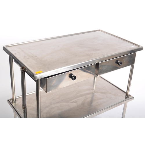 148 - A contemporary medical / industrial three tier stainless steel trolley, having twin drawer fitted fr... 