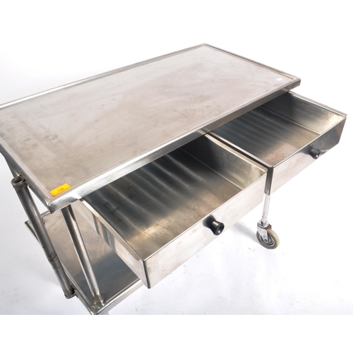 148 - A contemporary medical / industrial three tier stainless steel trolley, having twin drawer fitted fr... 