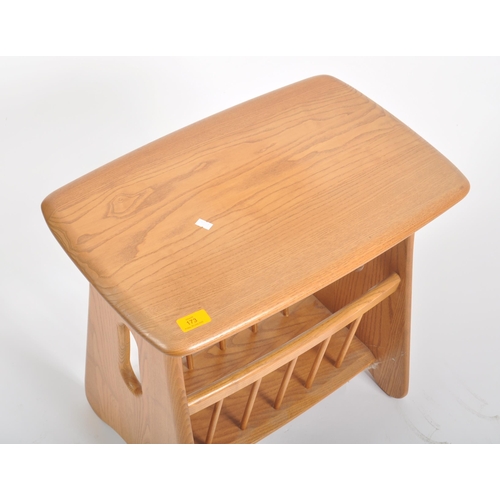 173 - An Ercol contemporary Windsor range blond elm wood magazine table. Pebble style tabletop with magazi... 