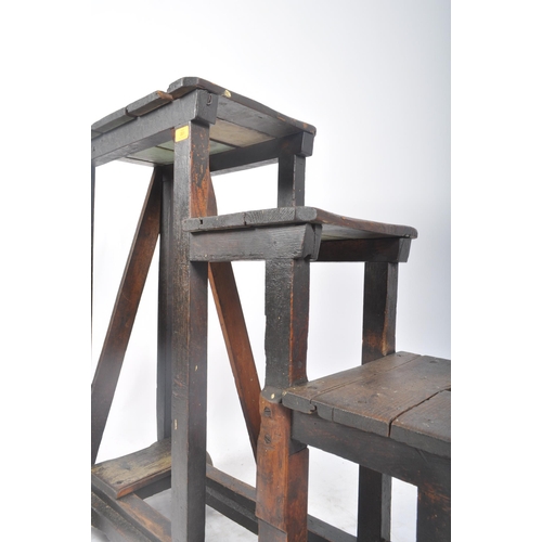 201 - A large early 20th century stained pine wood industrial railway / mill steps ladder on wheels. The t... 