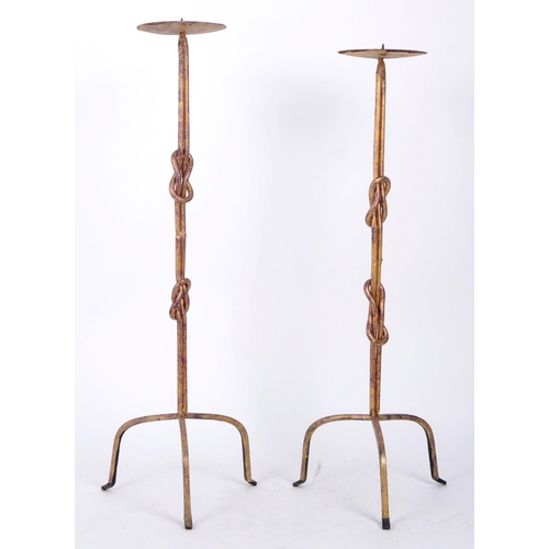 211 - A pair of vintage 20th century Brutalist style wrought iron floor standing prickets. Each candlestic... 