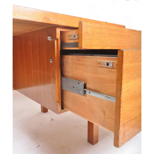 245 - Gordon Russell - A large retro vintage mid 20th century circa 1960s designer teak desk. The desk hav... 